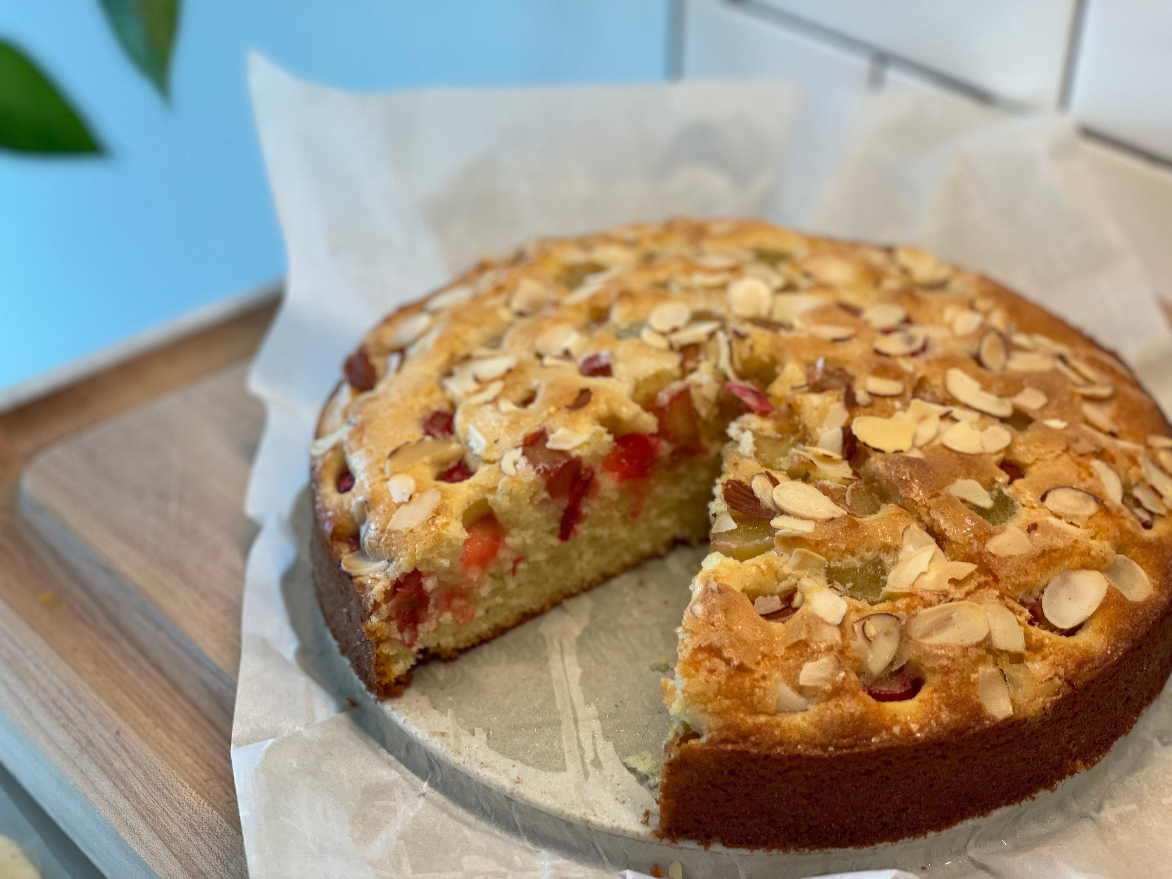 A simple yellow cake topped with bits of rhubarb and sliced almonds. 