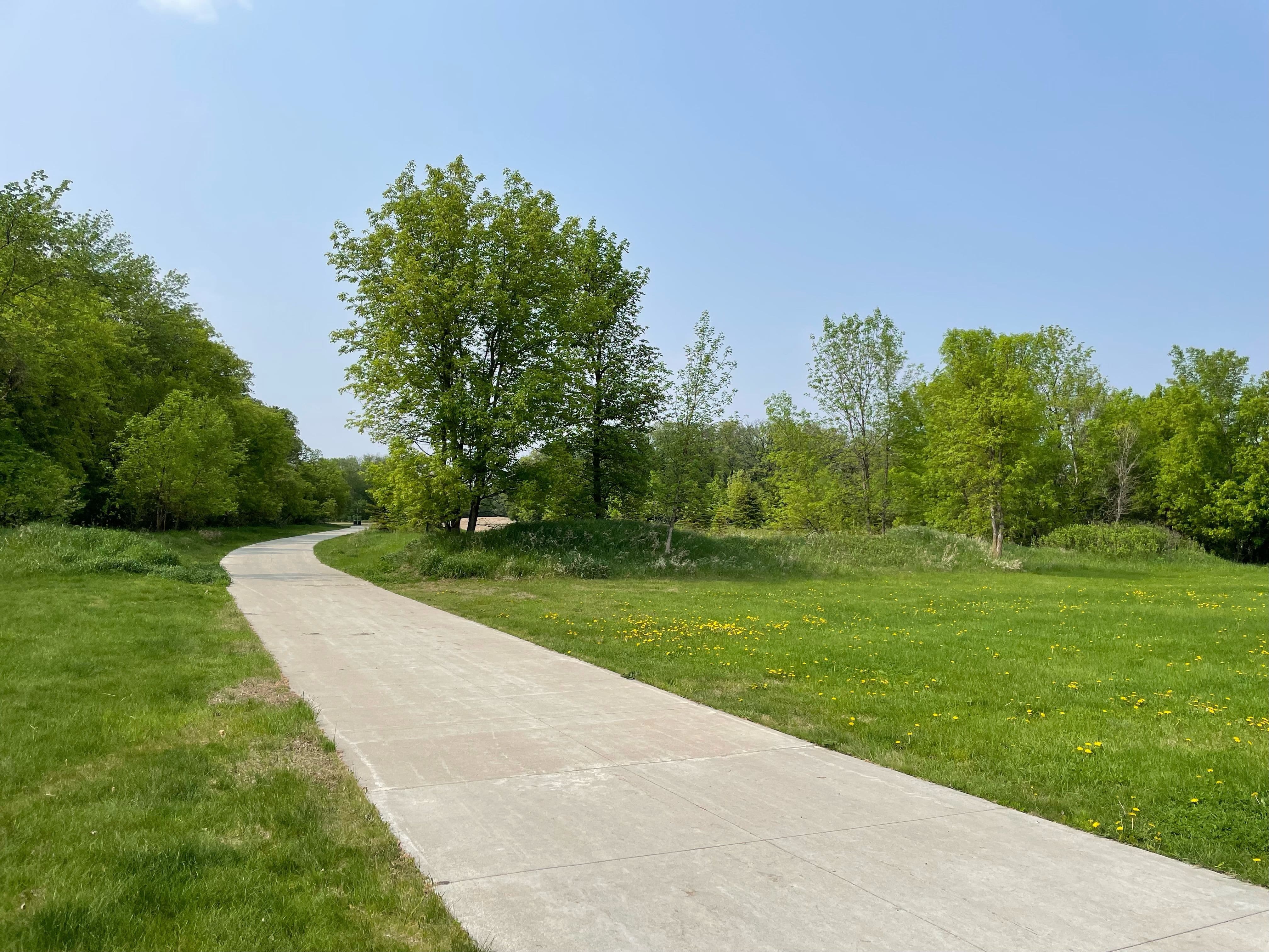 A paved trail offers opportunities for all to be surrounded by nature.